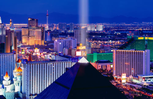 Grass and brush filled desert valley in front of the snow covered mountians of Red Rock Canyon Nevada