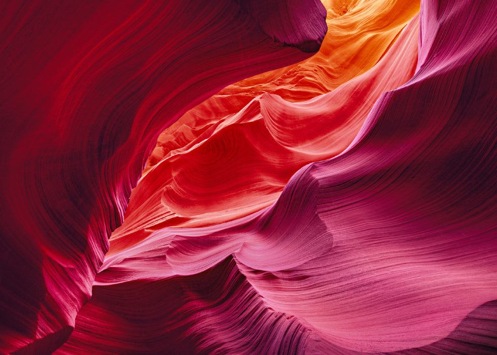 Red orange yellow and pink wave shaped sandstone walls of the slot canyons in Antelope Canyon Arizona