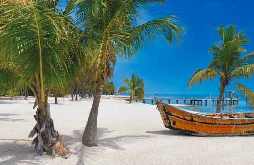 Old wooden jetty with white rope and lanterns leading over a turquoise ocean in Key West Florida