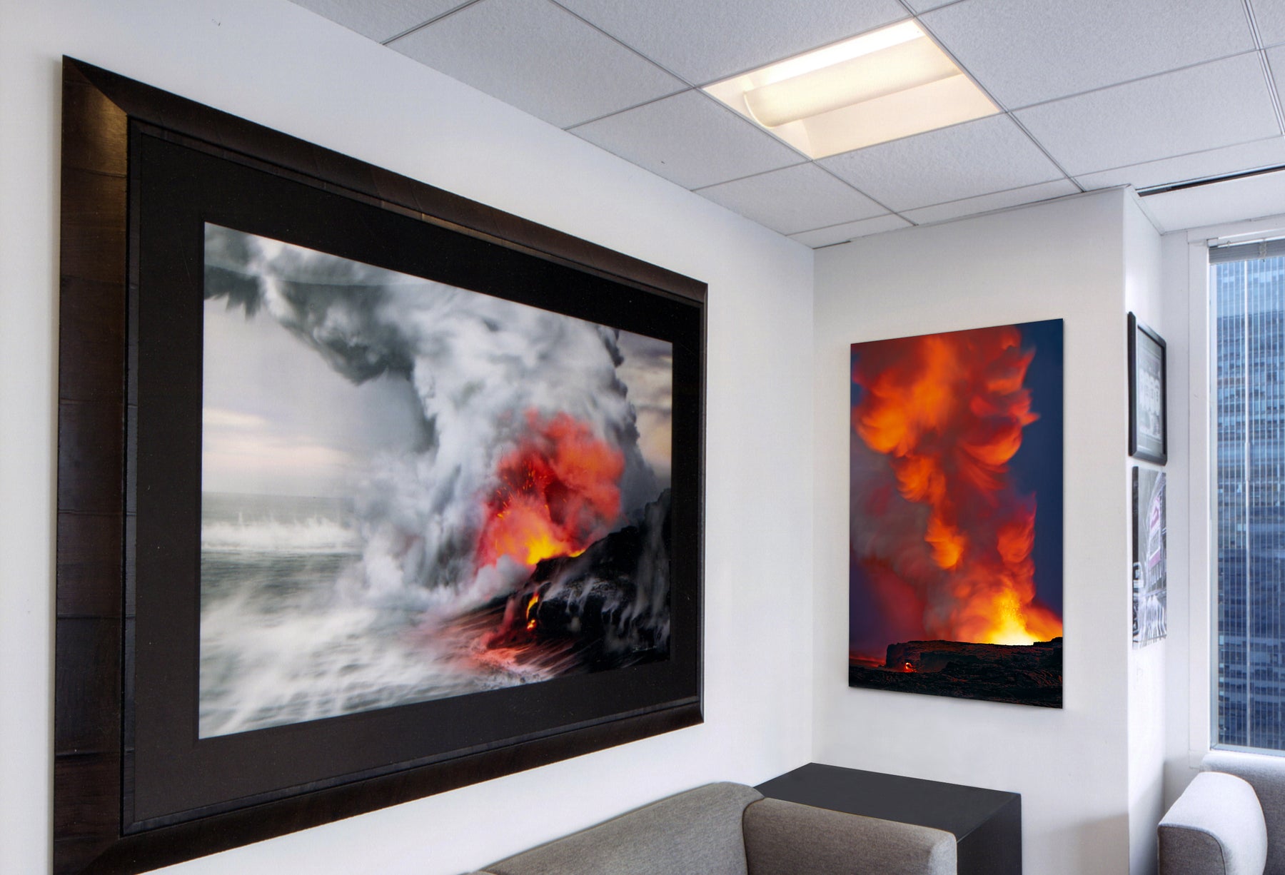 Corporate office featuring framed photographs by Peter Lik of volcanoes spilling lava into the Pacific Ocean