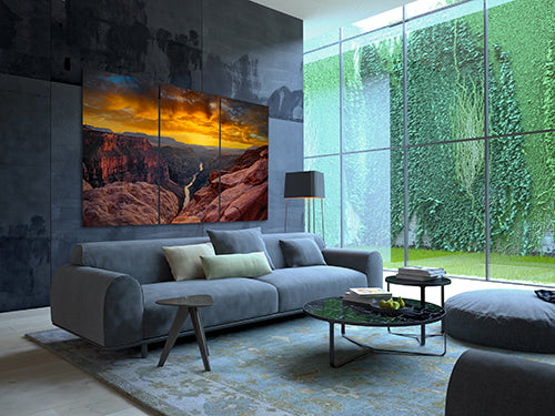 Large fine art photograph of the Grand Canyon photographed by Peter Lik hanging on the wall behind a couch in a modern living room