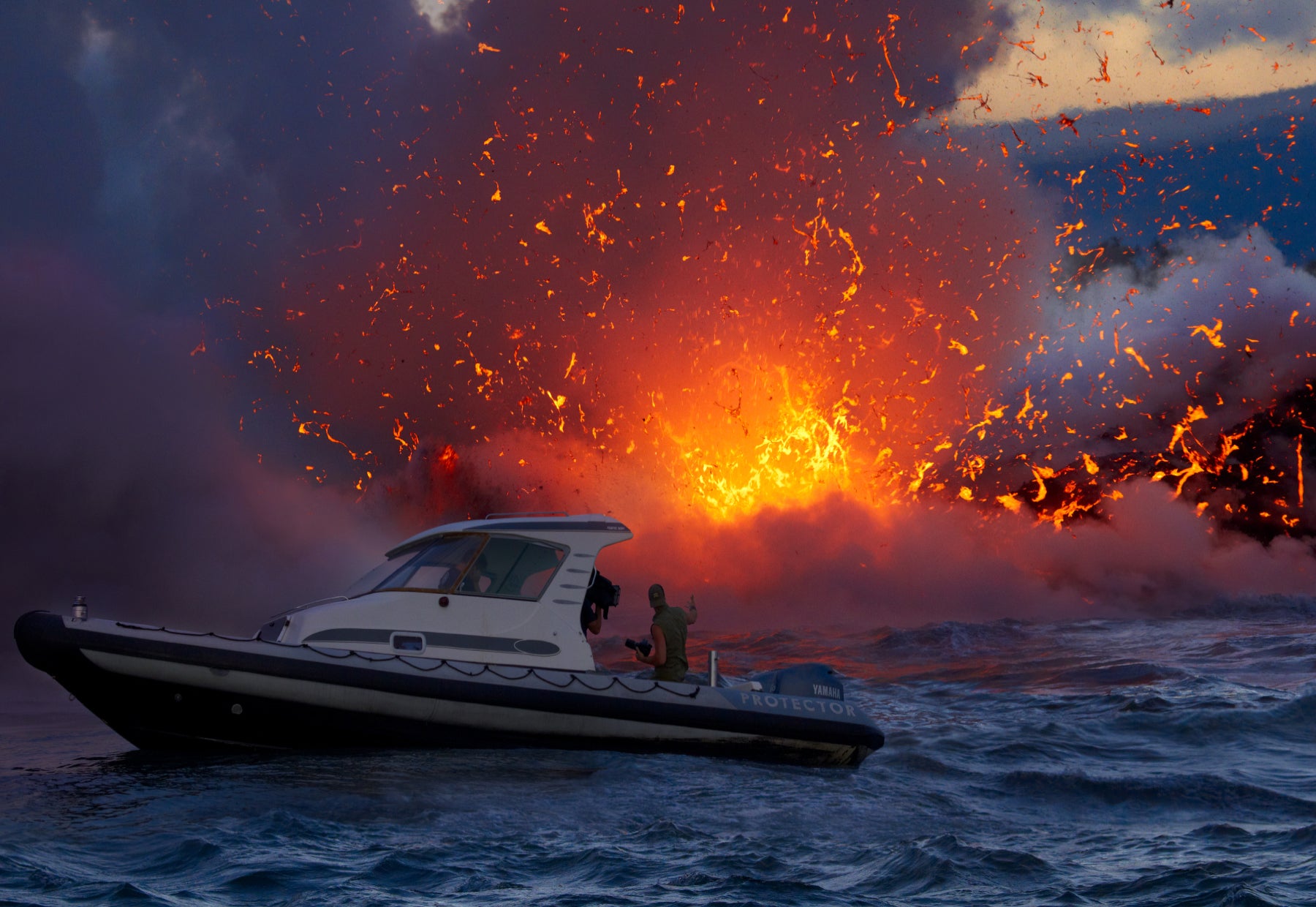 Silhouetted portrait of Peter Lik standing on the back of a boat off the coast of Hawaii as explosions of hot lava pour into the ocean in the background