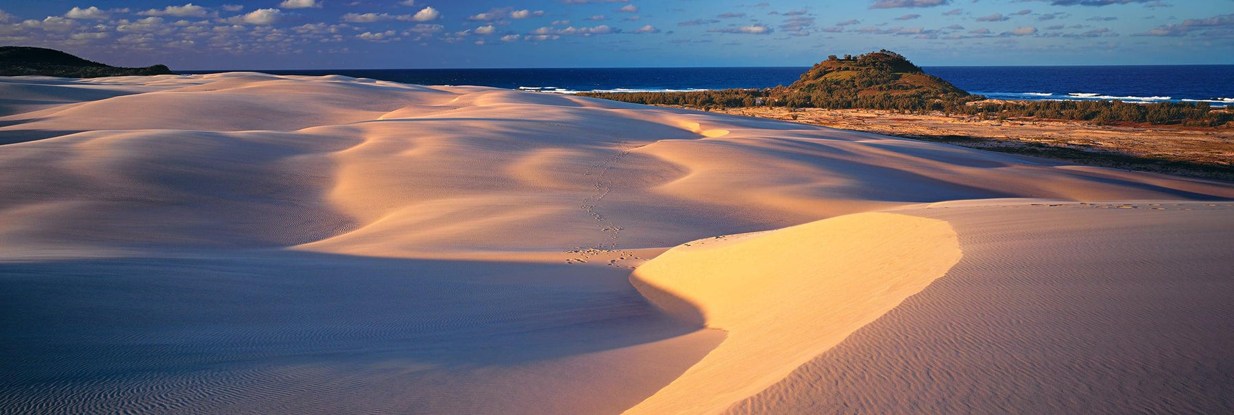 Windswept sand dunes covered with shadows along the coast of Fraser Island Australia