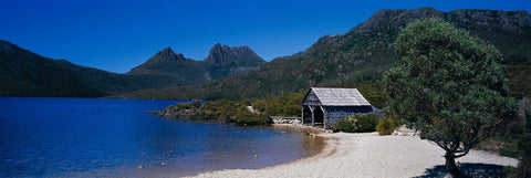 Old wooden boathouse on the sandy shores of Dove Lake in Australia 
