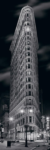 Looking up at the triangle shaped Flatiron building from the streets of New York City