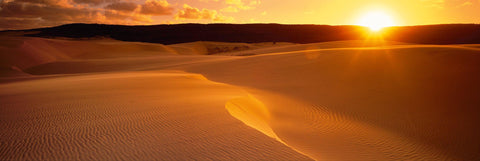Sun shining over the golden sand dunes of Fraser Island Australia