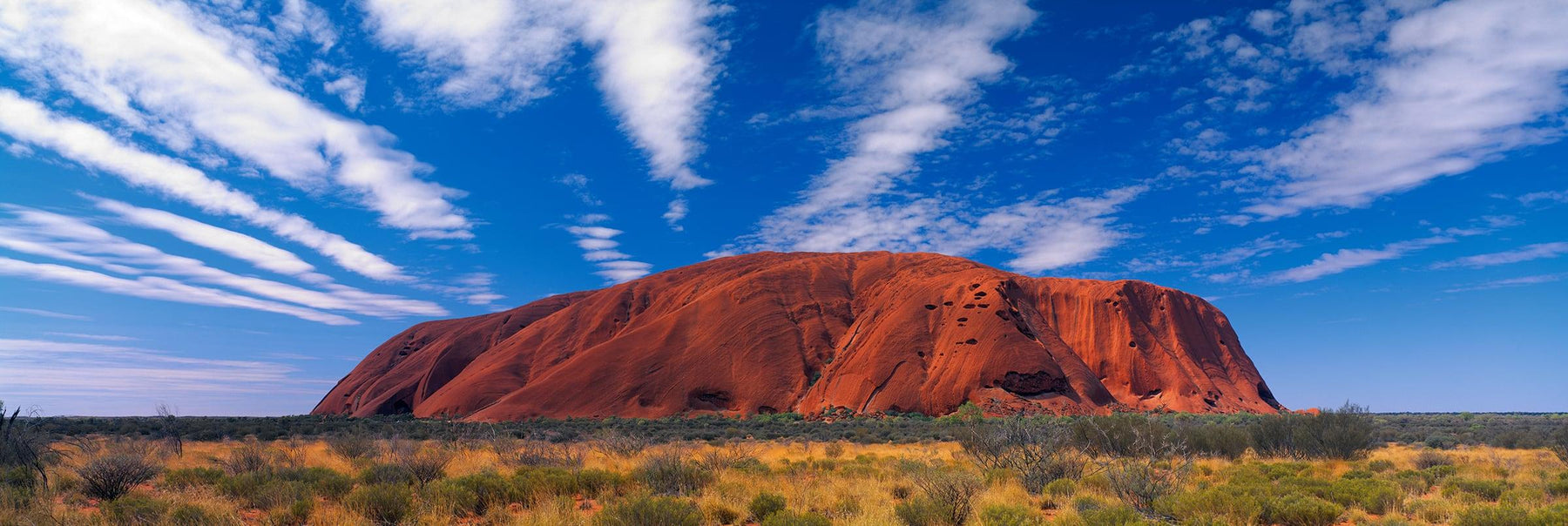 Massive sandstone monolith in the brush covered Northern Territory of Australia