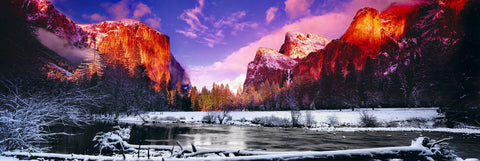 River running through the snow covered Yosemite Valley with El Capitan mountain in the background