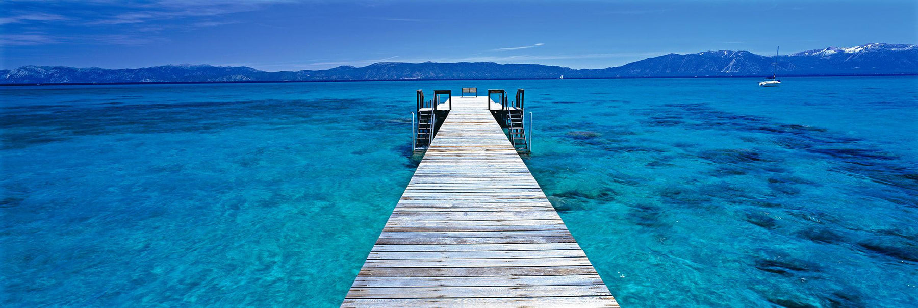 White wooden jetty stretching over the turquoise waters of Lake Tahoe California