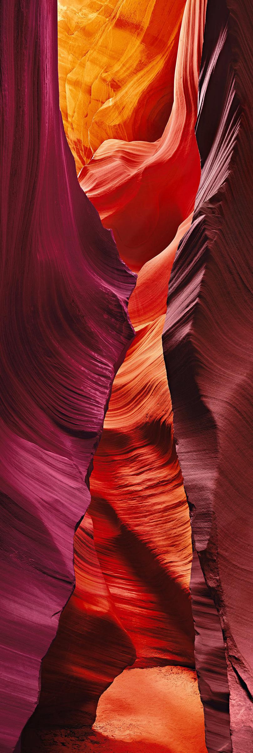 Sand path through the red orange and pink sandstone walls of the slot canyons in Antelope Canyon Arizona