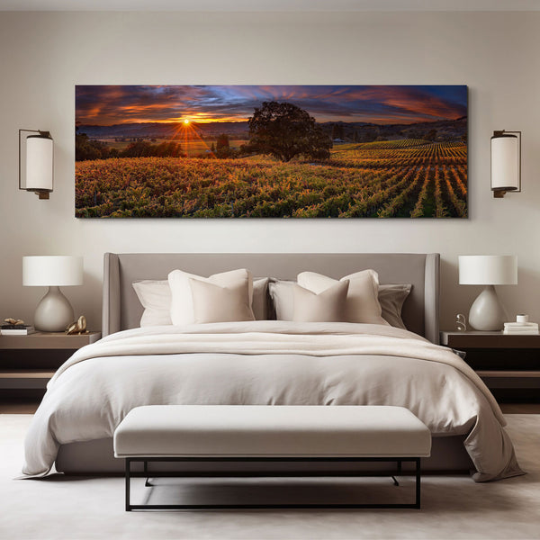 Peter Lik acrylic mounted photograph of a old tree in the middle of a California Vineyard at sunset hanging above a grey bed with white sheets in a master bedroom.