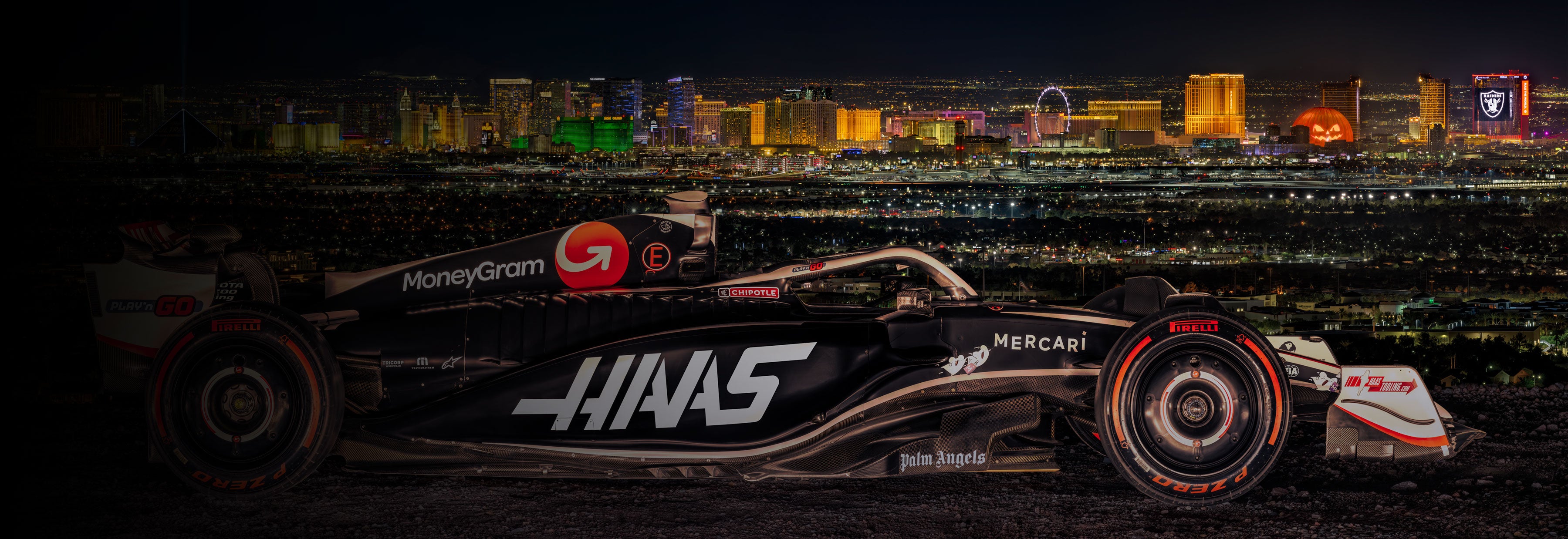 LIK Fine Art photograph of the MoneyGram Haas F1 Team car in front of the Las Vegas strip at night. 