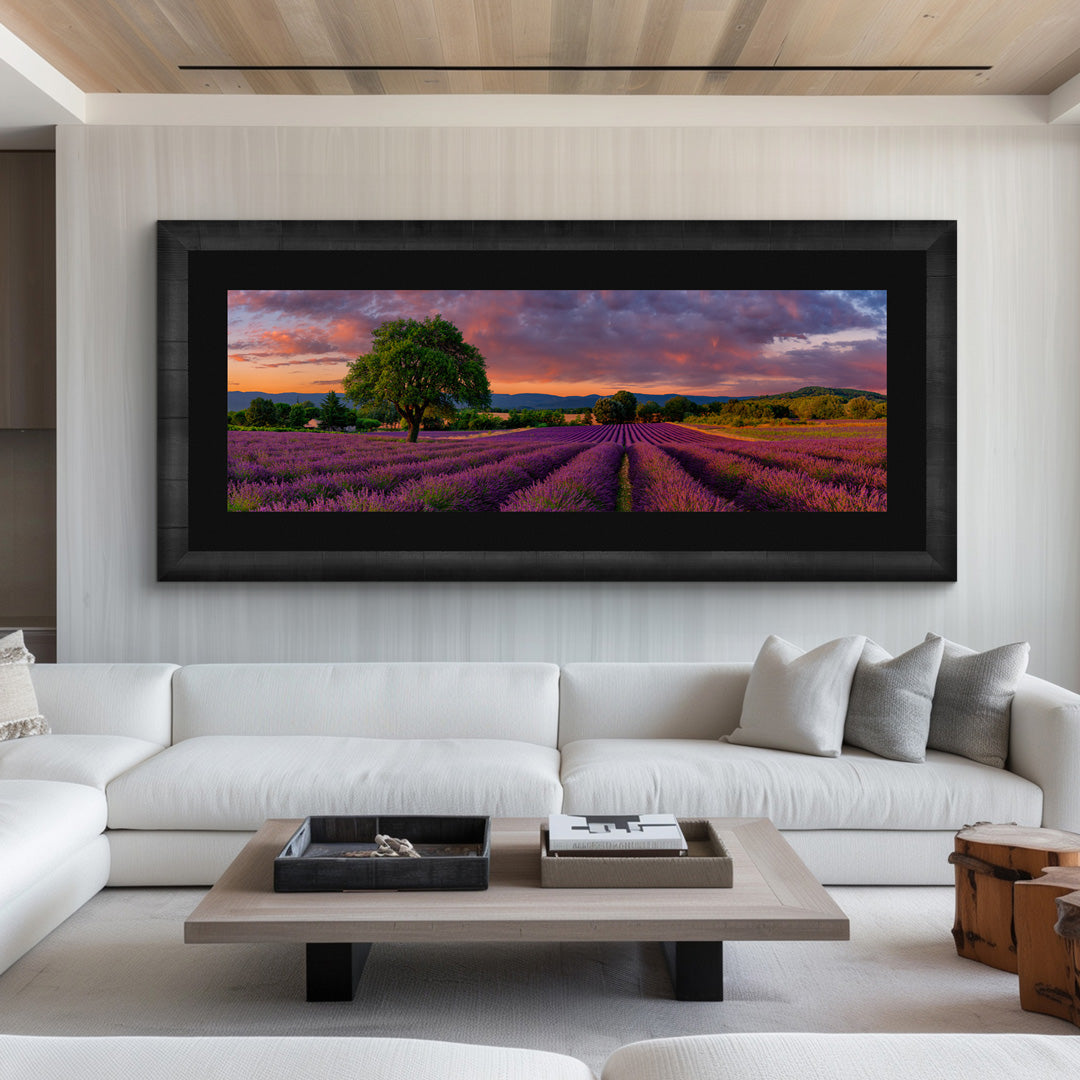Framed Peter Lik fine art photograph featuring a tree in the lavender fields of France at sunset, hanging over a white sofa.