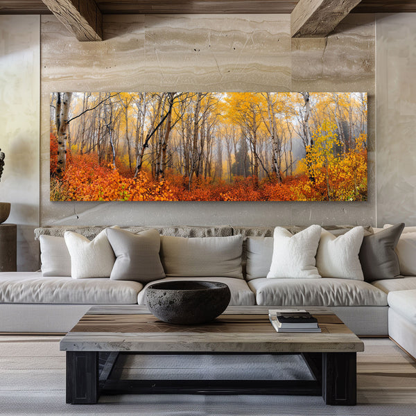 Photo of anAspen forest in peak autumn color with golden yellow leaves and vibrant orange undergrowth fading into soft morning mist — a serene fall landscape of tall white trunks and glowing foliage hanging on a wall in a living room.