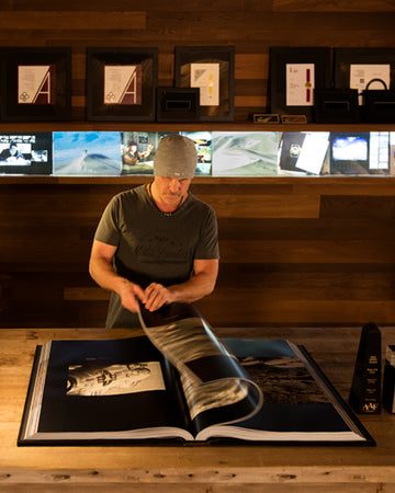 Peter Lik flipping through his epic book, Equation of Time in his corporate studios in Las Vegas, Nevada.