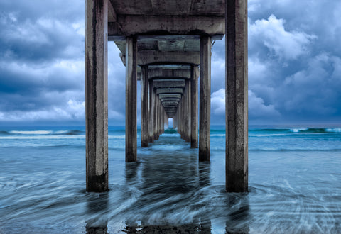 Endless Horizon by LIK Fine Art showing Scripps Pier in La Jolla with ocean waves and dramatic storm light.