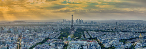 The Eiffel Tower glows in golden light, capturing Paris's timeless elegance and Olympic spirit.