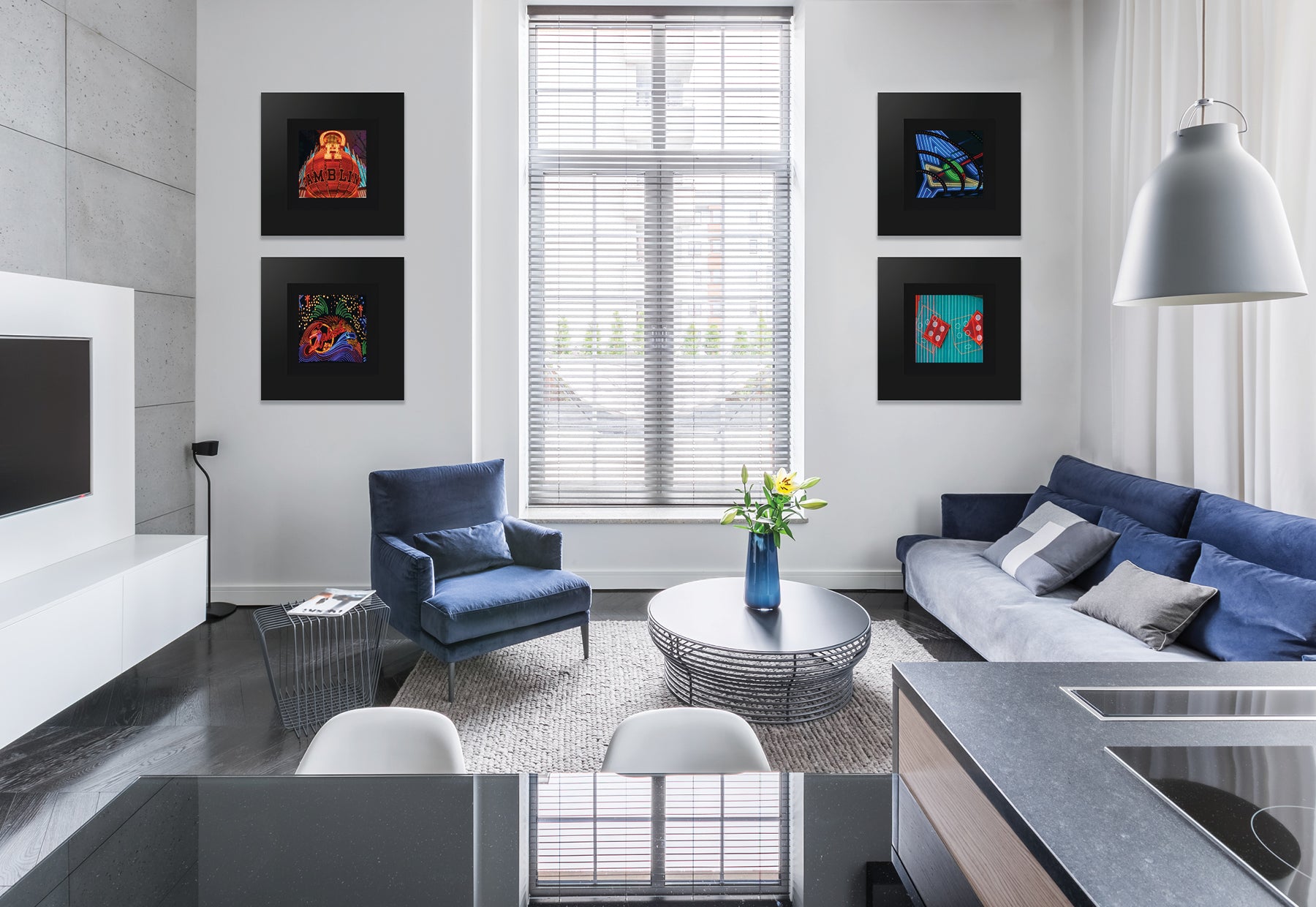 Modern home interior with blue couch and chair featuring four square photographs of Las Vegas landmarks by Peter Lik in matte black frames and black liners