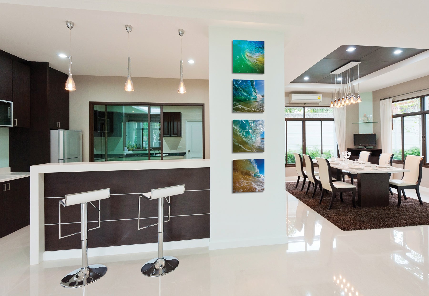 Modern kitchen and dining interior featuring four square photographs of ocean waves by Peter Lik hanging next to bartop