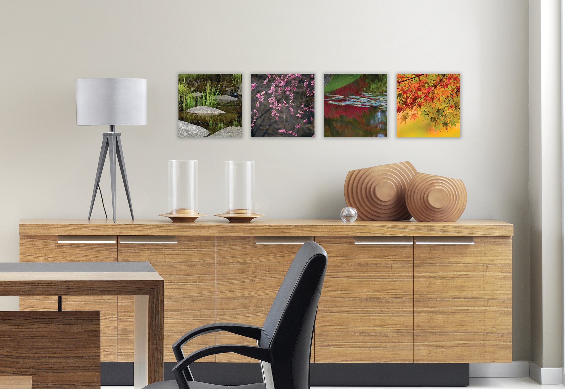 Modern dining room with light brown wood console table with sculpture and lamp featuring four square photographs by Peter Lik of traditional Zen gardens