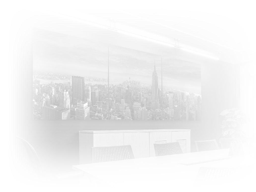 Light gray background of a corporate conference table with a framed 3-panel photograph of Manhattan, New York with Empire State Building