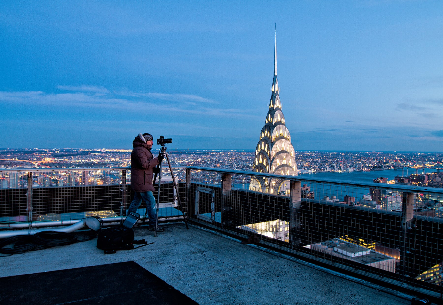Portrait of Peter Lik captured on the roof of the Met Life Building overlooking the Chrysler Building and city lighting up during twilight