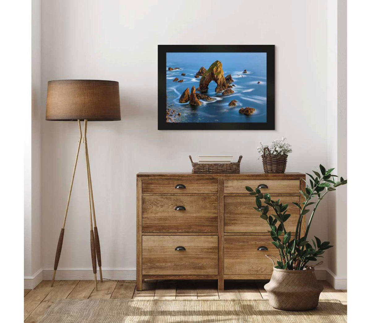 LIK Fine Art photograph featuring seaside rocks in Ireland, displayed above a dresser in a bedroom.