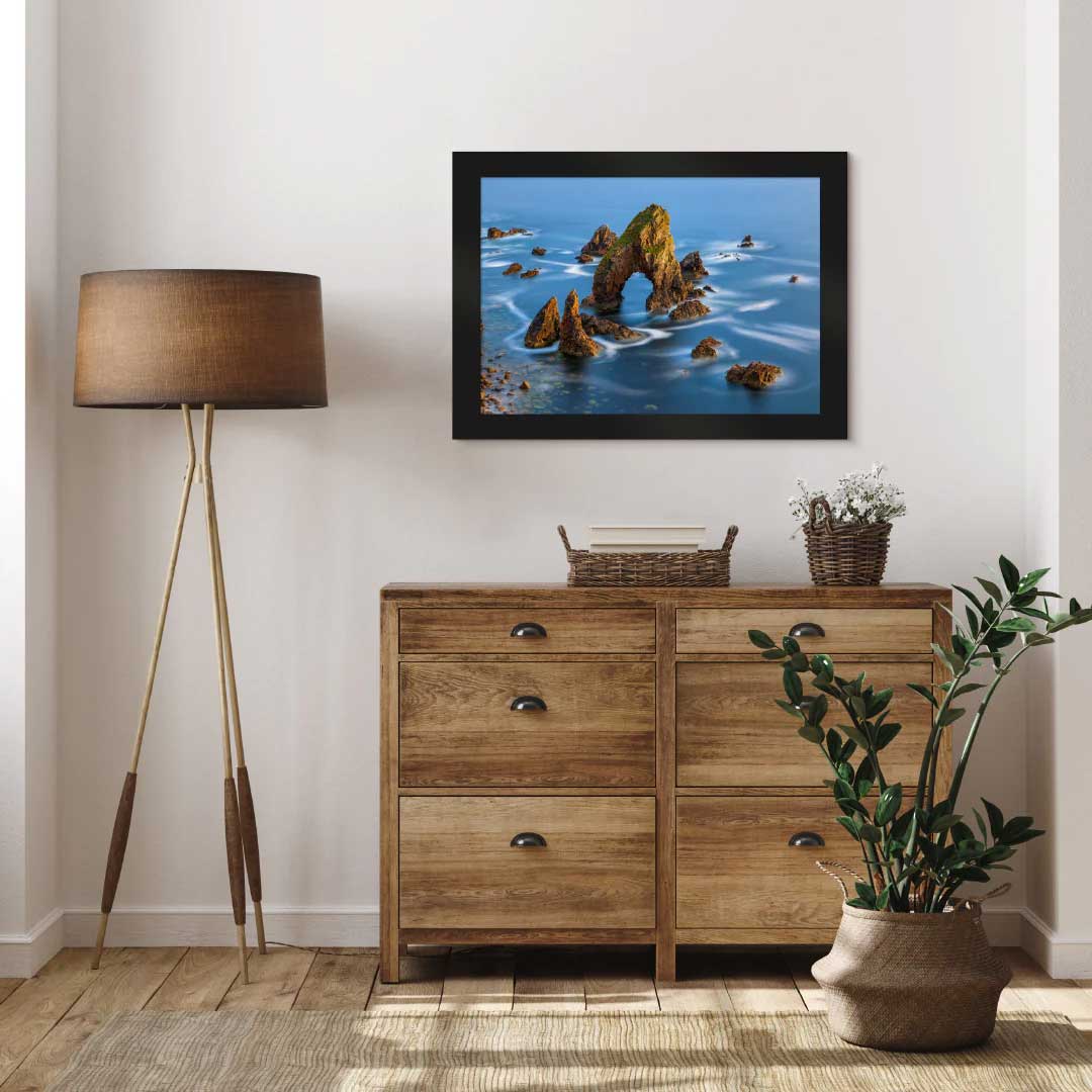 LIK Fine Art photograph featuring seaside rocks in Ireland, displayed above a dresser in a bedroom.