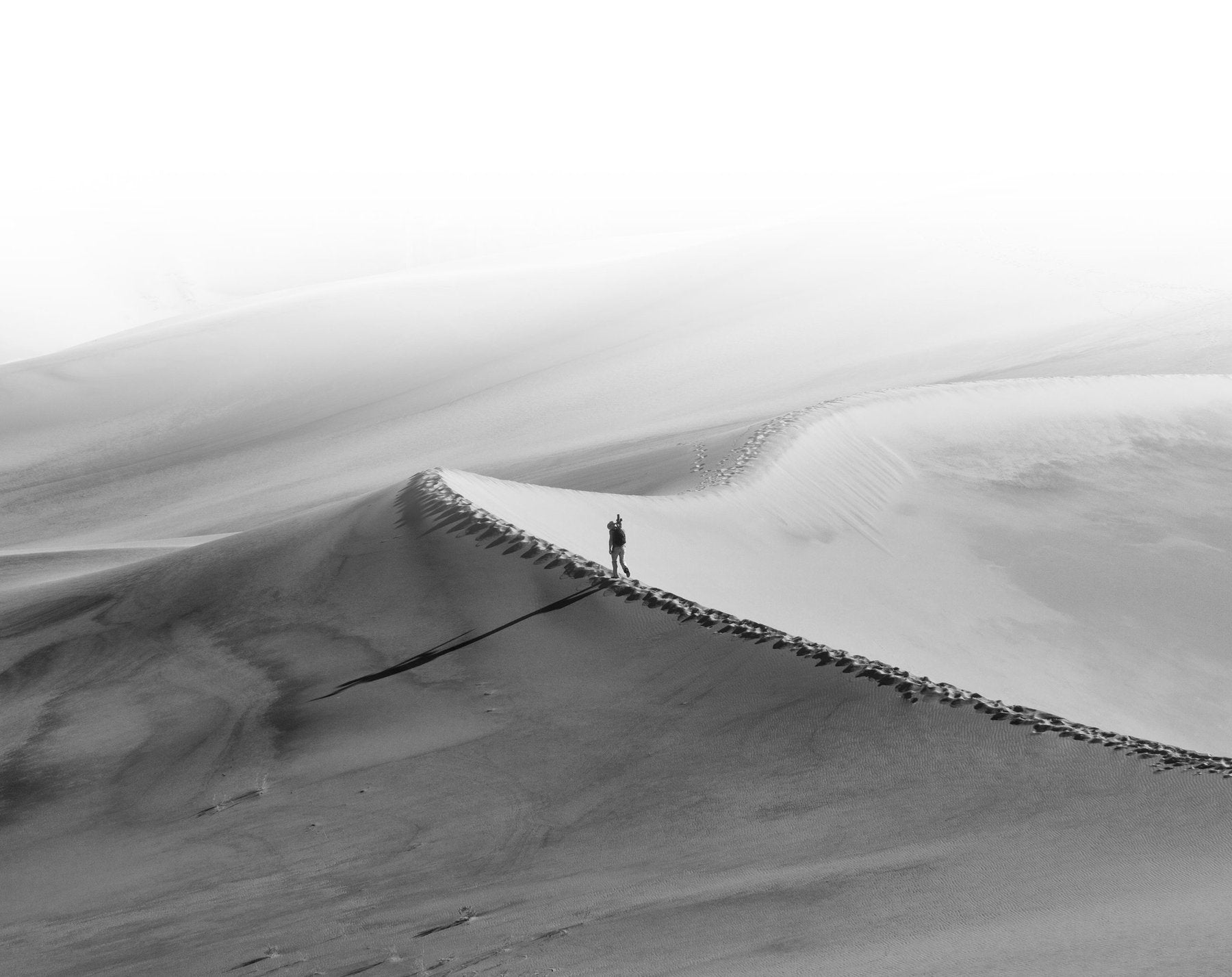 Peter Lik walking across the Mesquite Flat Sand Dunes in Death Valley National Park in California. 