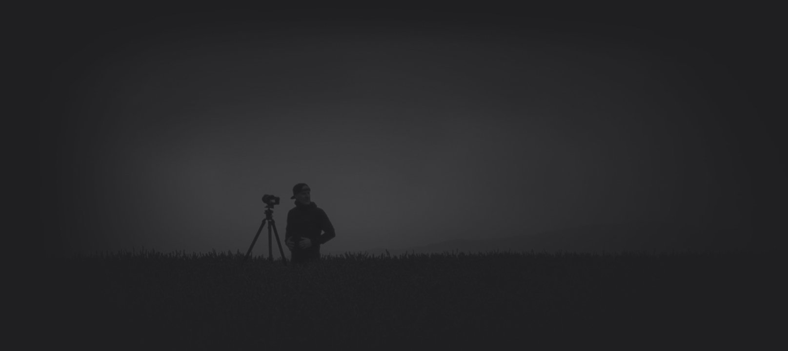 Portrait of Peter Lik standing in the lavender fields of Valensole, France with his camera on a tripod.