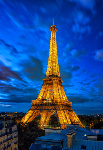 Eiffel Tower shines amid golden clouds, celebrating Paris as a beacon of history and global unity.