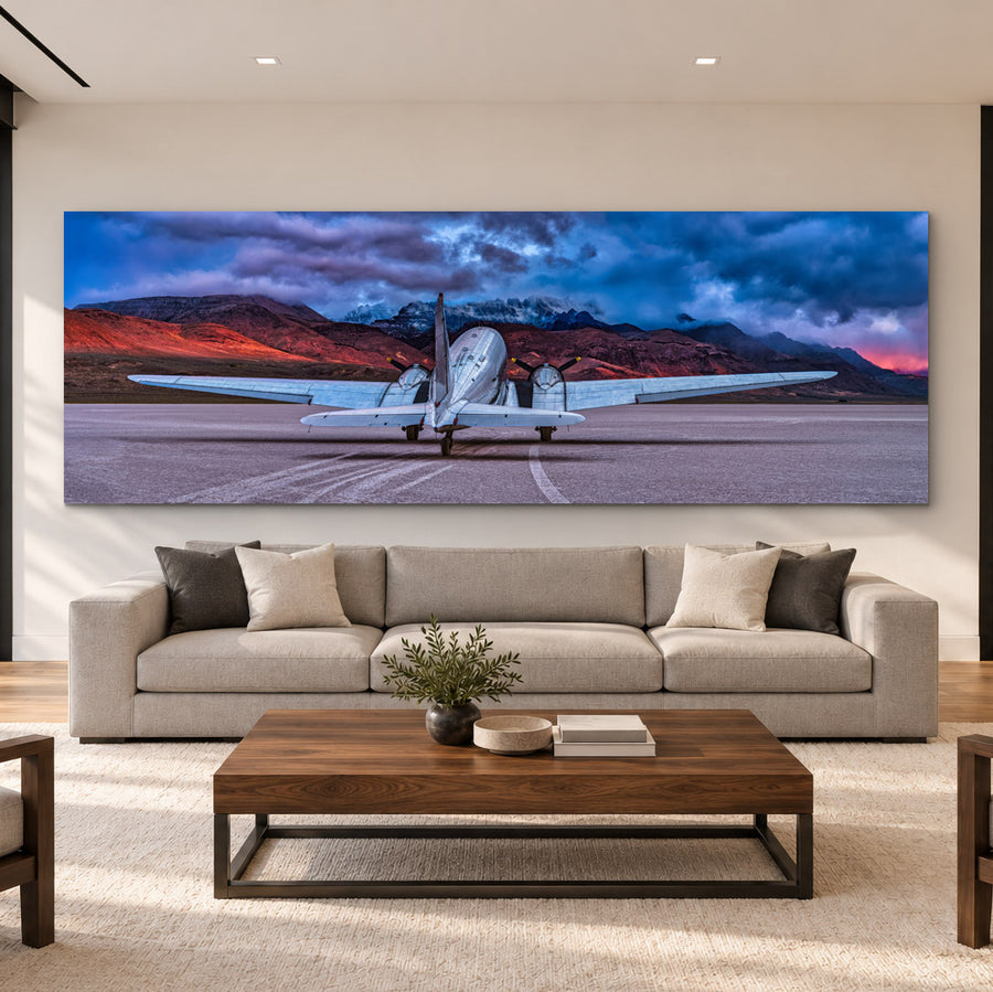Peter Lik's The Art of Flight panoramic aviation photograph displayed above a contemporary sofa in a luxurious, sunlit living room.