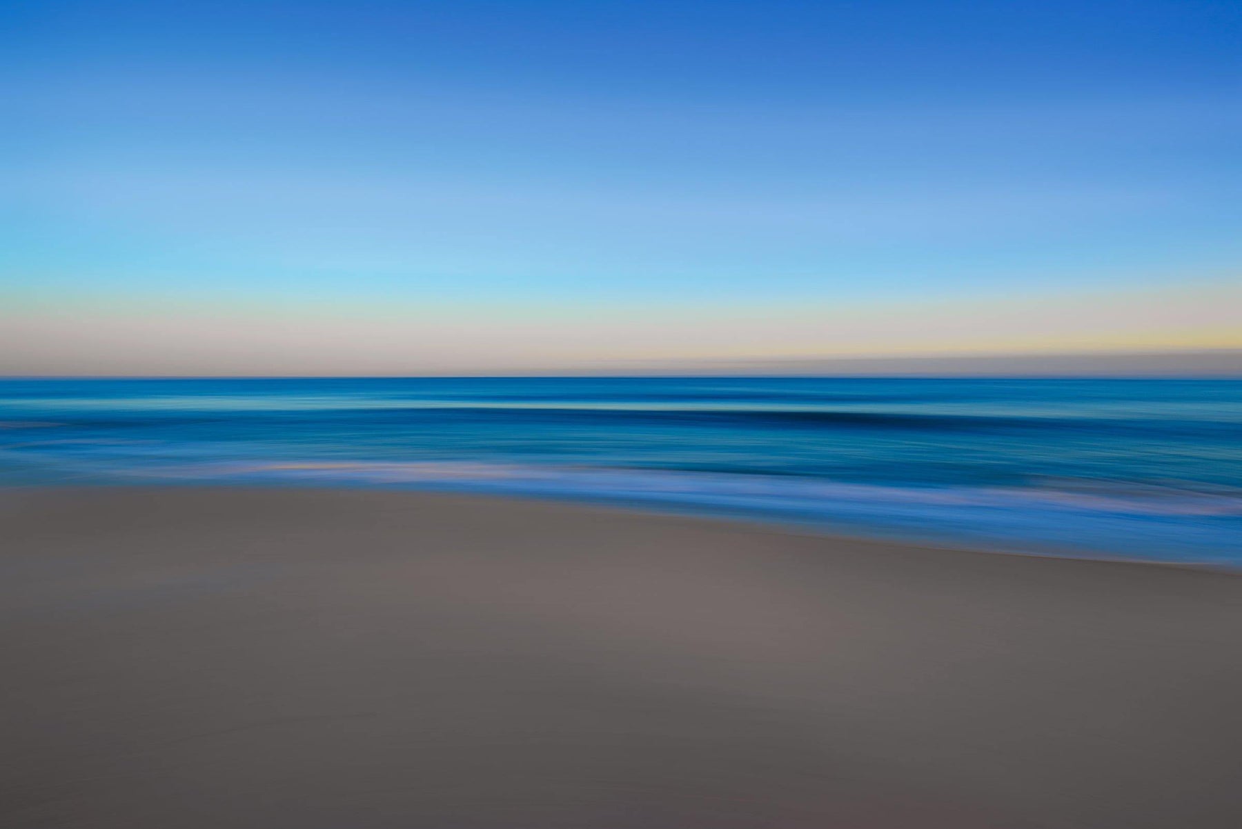 Blurred sand beach ocean and sky in Montauk Long Island
