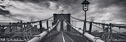 Black and white wooden path leading down the middle of the Brooklyn Bridge New York