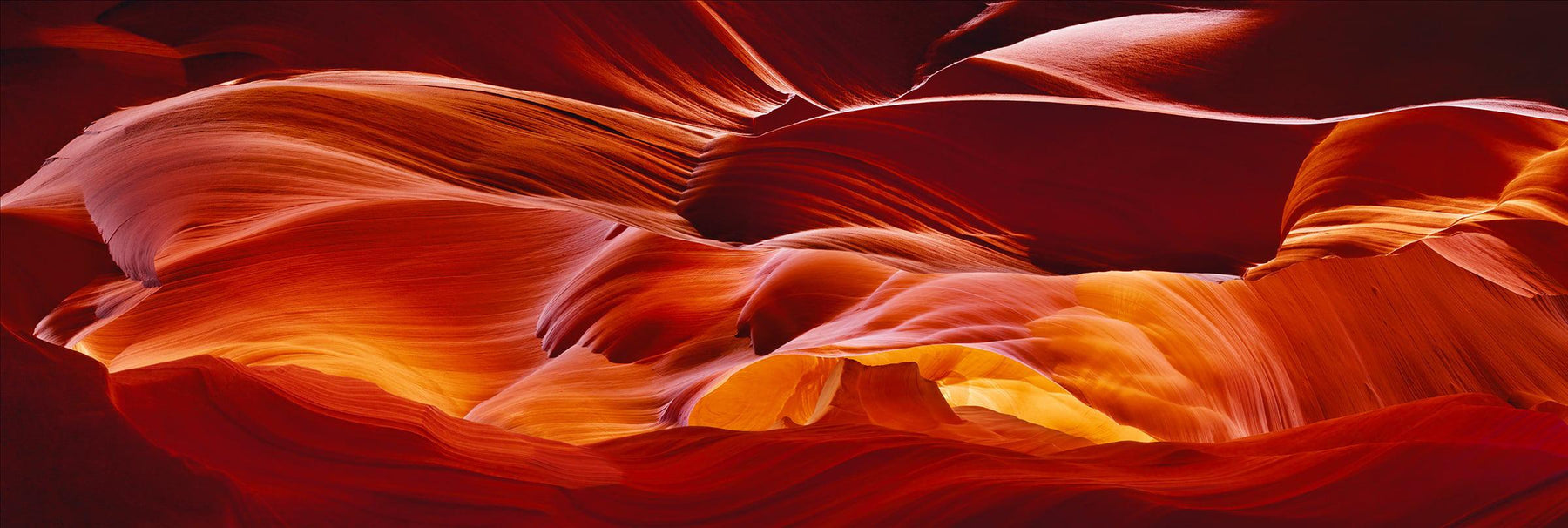 Red orange and yellow wave shaped sandstone walls of the slot canyons in Antelope Canyon Arizona