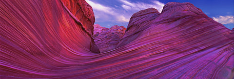 Pink and purple wave like rock formations in the slickrock hills of Vermillion Cliffs National Park Arizona