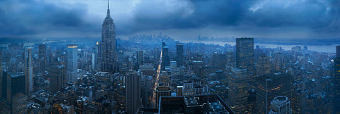Rooftop view of the Empire State building and New York City on a blue cloudy and overcast day