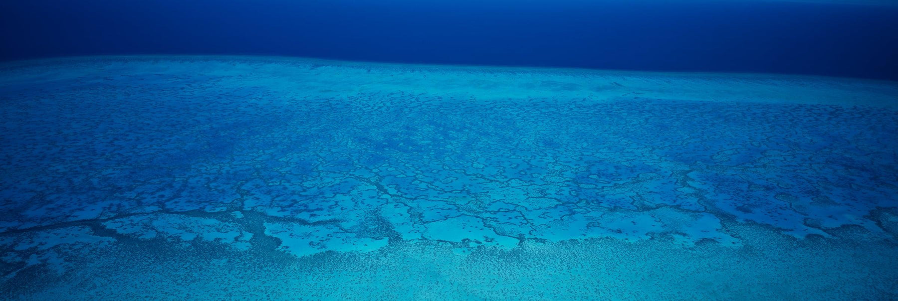 Aerial view of the Great Barrier Reef and ocean in Queensland Australia