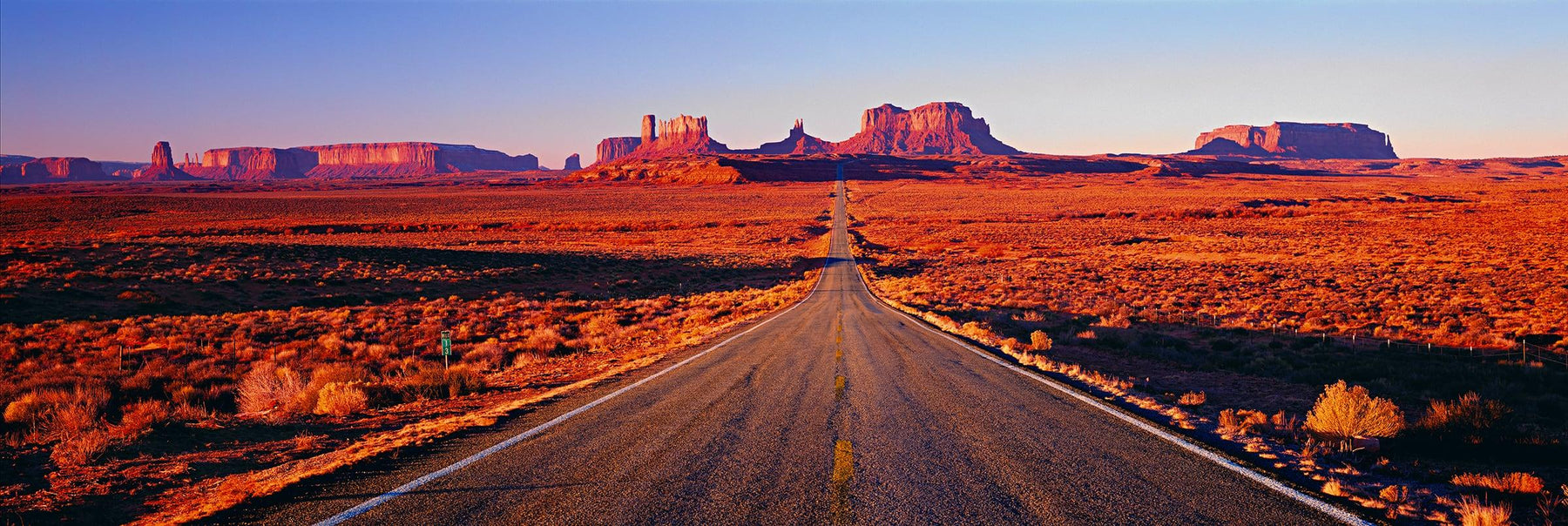 Looking straight down Highway 163 running into the sandstone buttes of Monument Valley Utah