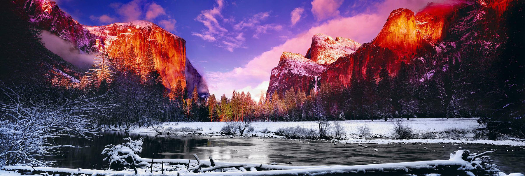River running through the snow covered Yosemite Valley with El Capitan mountain in the background