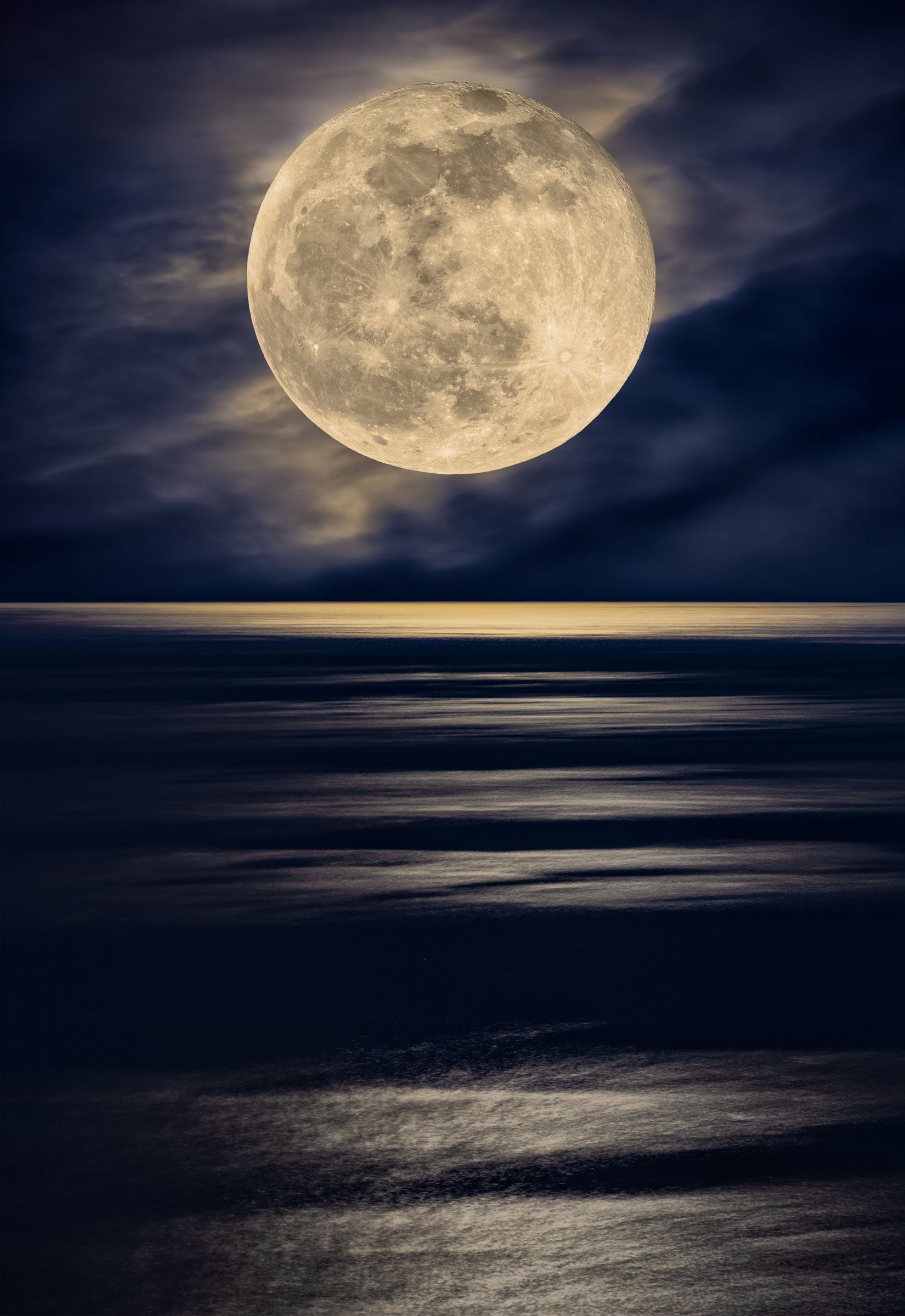 Photograph of the full moon shining off the the ocean from the coast of Ibiza, Spain by Peter Lik.