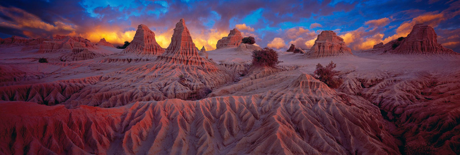 Sculptured towers of dirt in the remote outback in Mungo National Park Australia at sunset