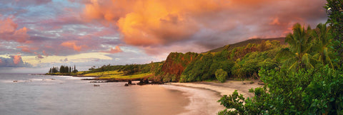 Clouds rolling over a tropical cove and beach in Maui Hawaii during sunset