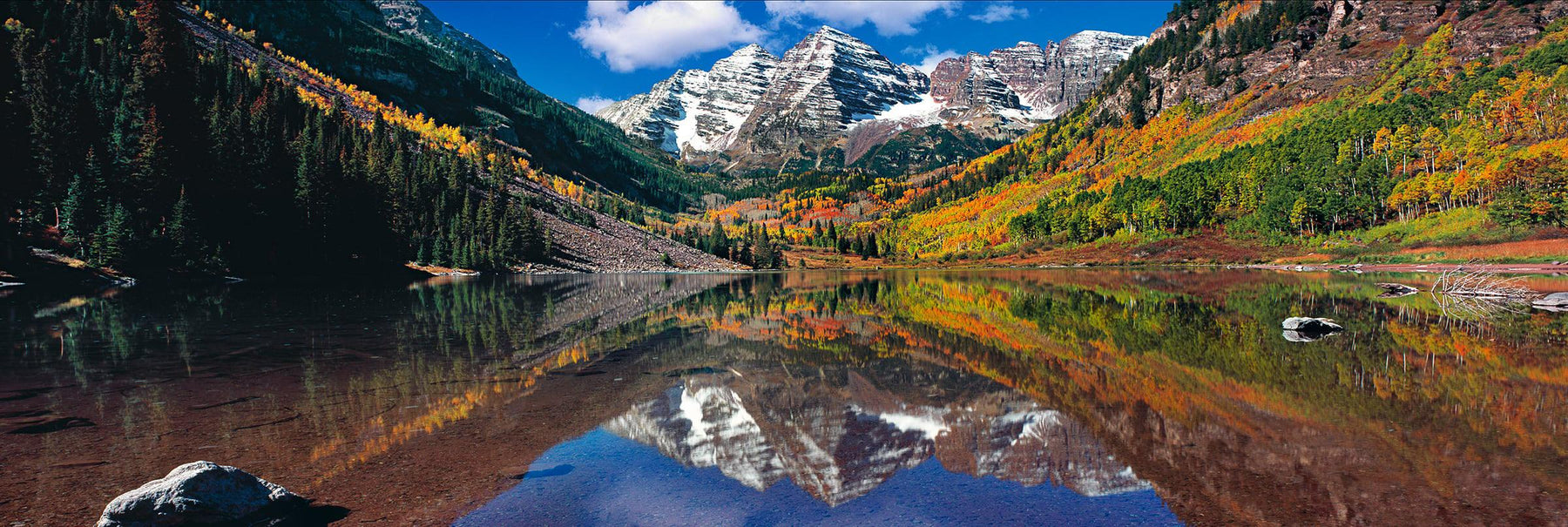 Maroon Lake reflecting the Autumn forest and two snow covered peaks of Maroon Bells Colorado