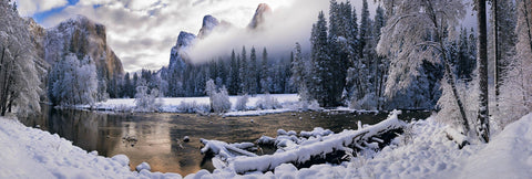 River running through the snow covered Yosemite Valley with El Capitan mountain in the background 