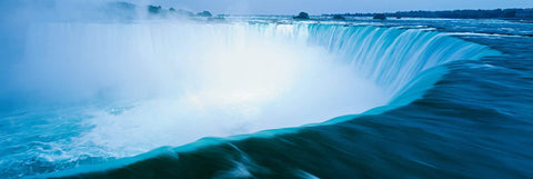 Giant turquoise waterfalls forming a horseshoes shape at Niagara Falls New York