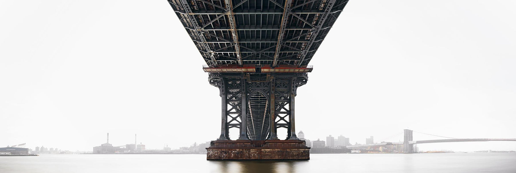 View from under the Manhattan Bridge with the city of New York overexposed in the background