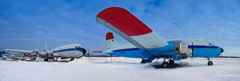 Two old airplanes sitting in a snow covered field in Fairbanks Alaska