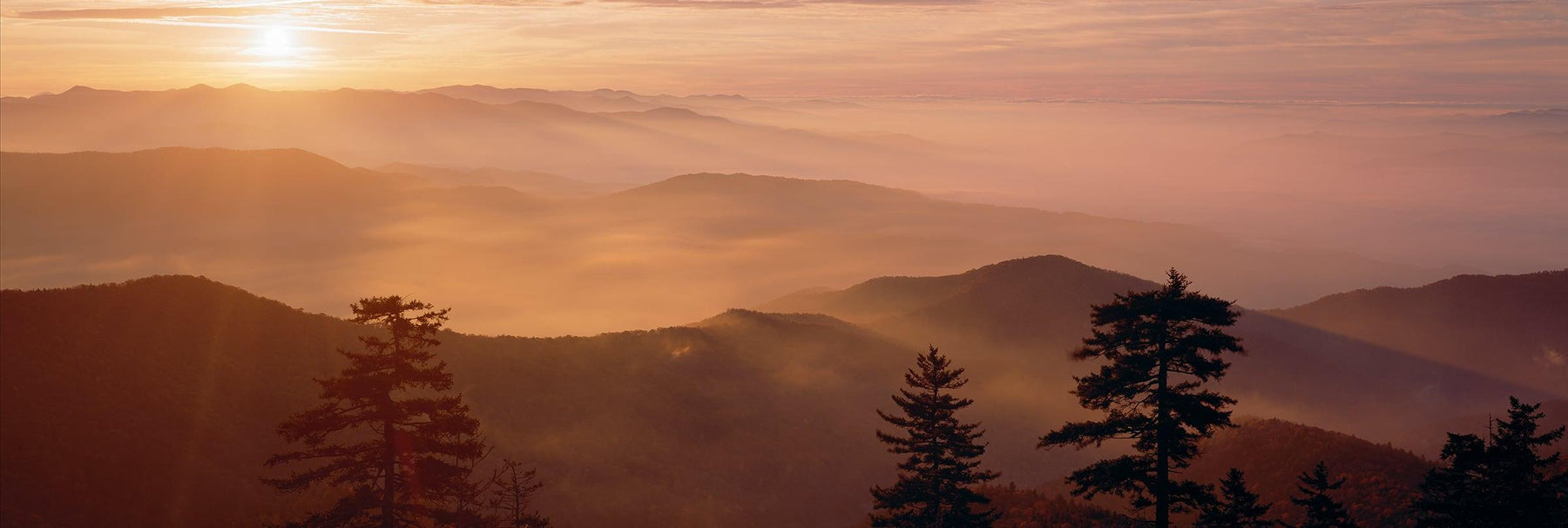 Sun setting over the misty mountain tops of the Great Smoky Mountains National Park Tennessee