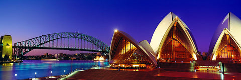 Sydney Opera House and Sydney Harbor Bridge lit up at sunset